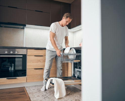 man using the dishwasher
