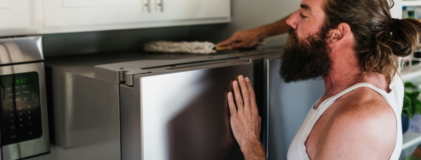 man cleaning the refrigerator